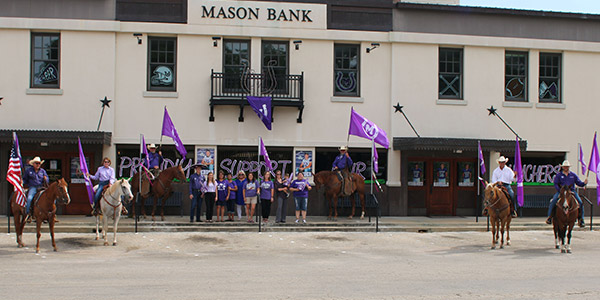 Mason Bank group photo with cowboys on horse and flags